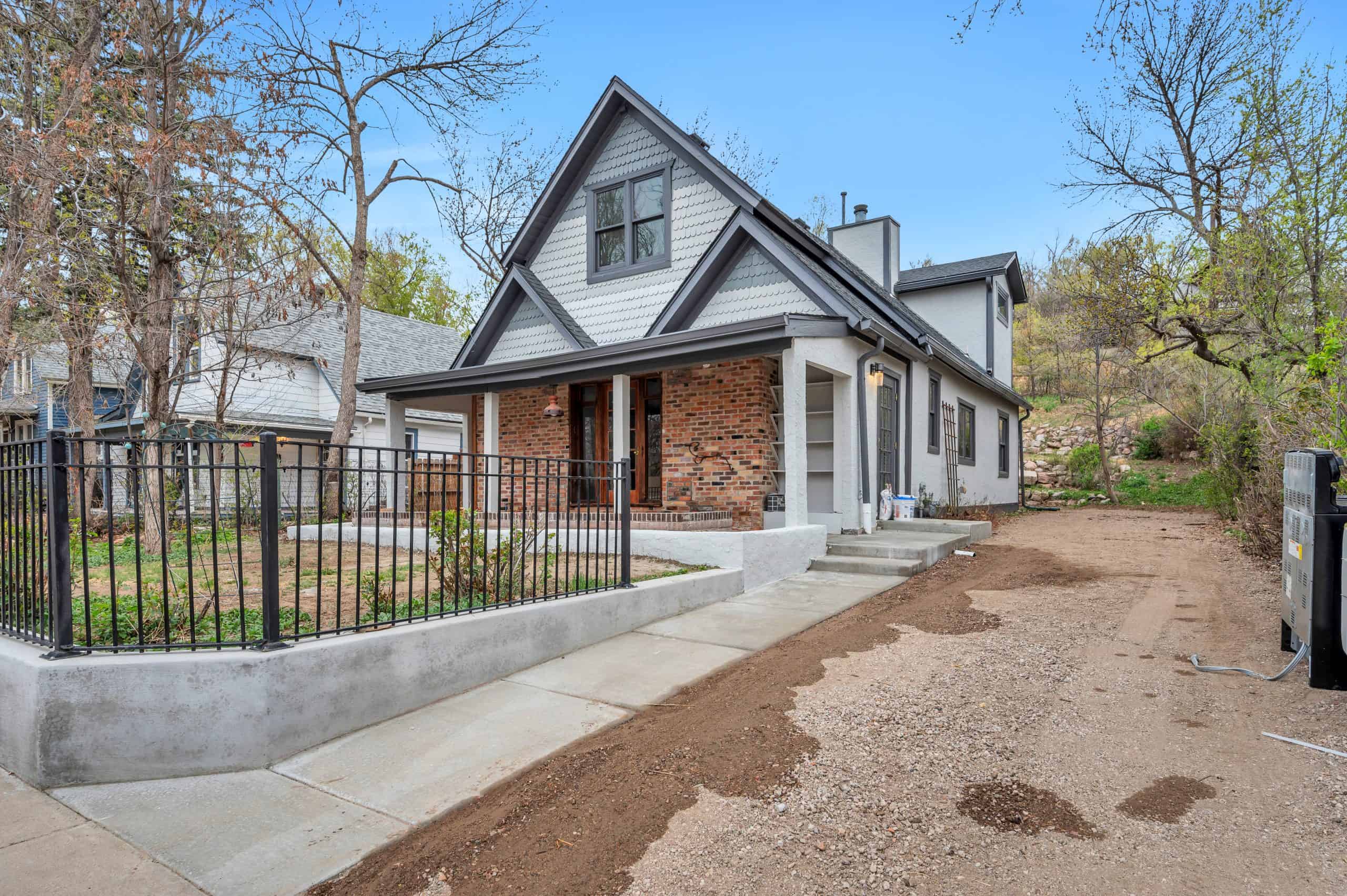 Exterior house painting Colorado Springs – modern two-story home with brick and white siding